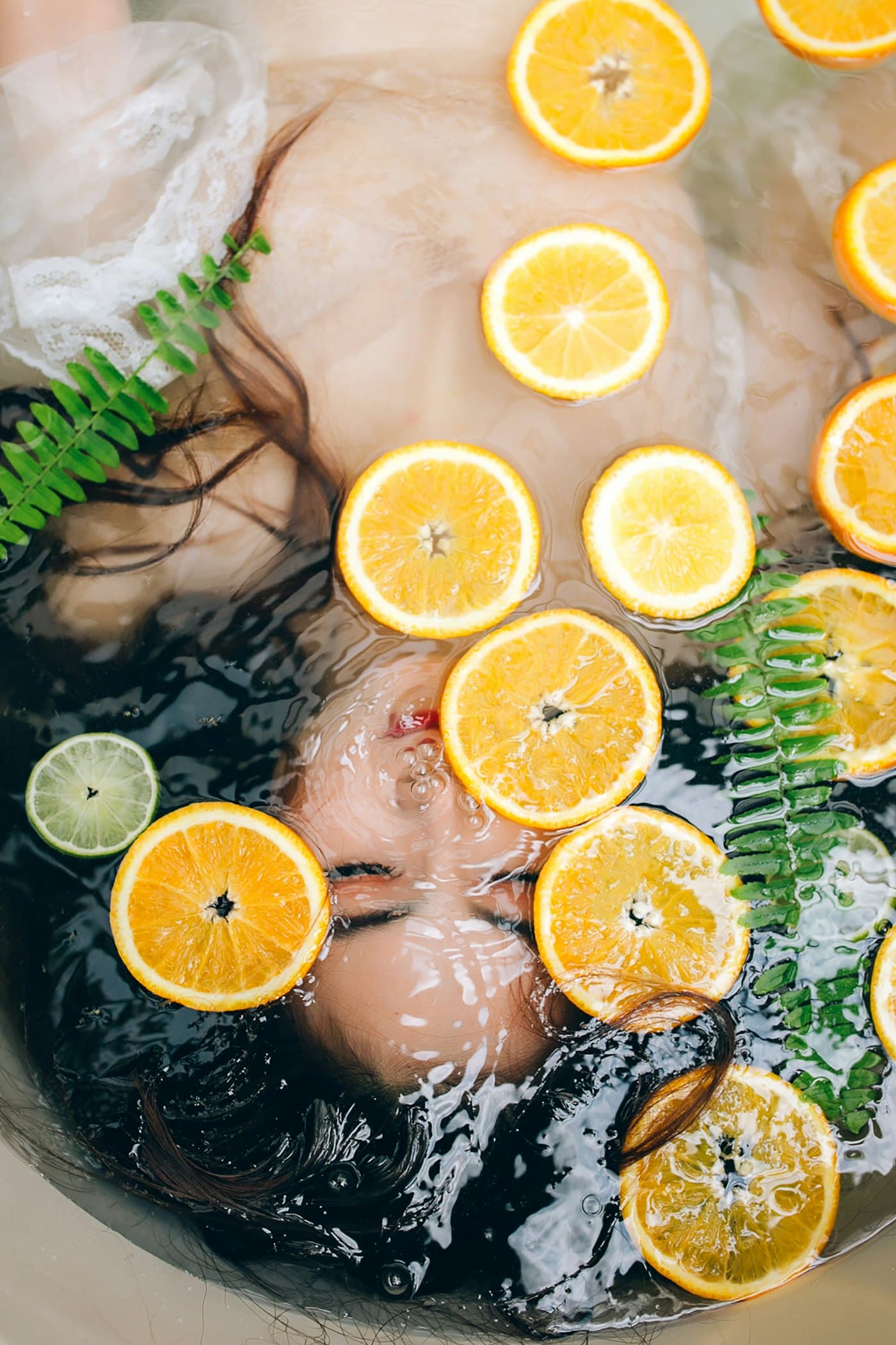 Citrus slices floating in a bath